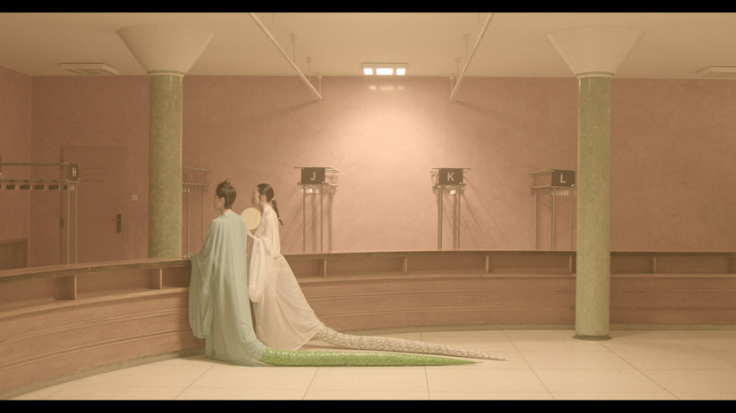 Installation view of Curses: Final Girls: multiple screens in a darkened gallery space show different women in horror-inspired scenes, forming a multi-channel video installation about curses, fear and survival.